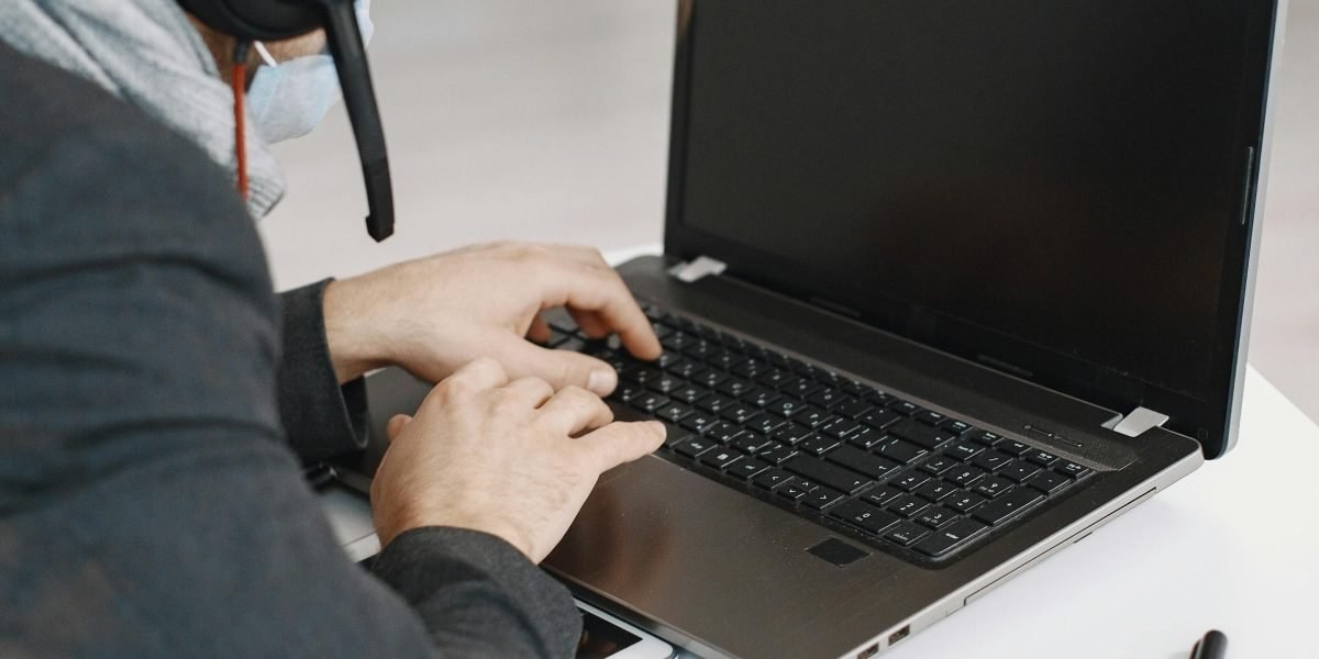 Remote appointment setter working on a laptop with headset